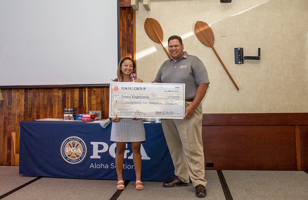 Avery Kageyama receiving a scholarship check